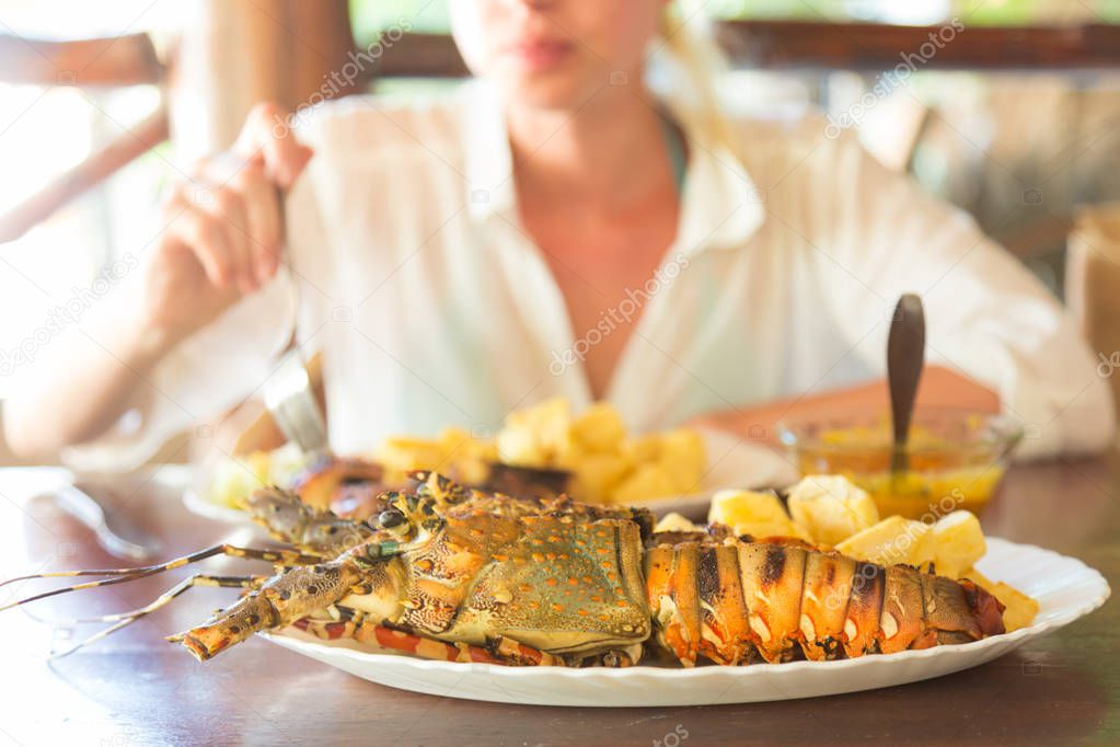 Grilled lobster served with potatoes and coconut sauce.
