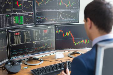 Üzerinde omuz görünümü stok komisyoncu online ticaret ve bilgisayar ekranları.
