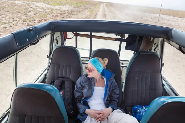 Mujer en safari de vida silvestre africana observando la naturaleza desde el jeep de safari de techo abierto . — Foto de Stock