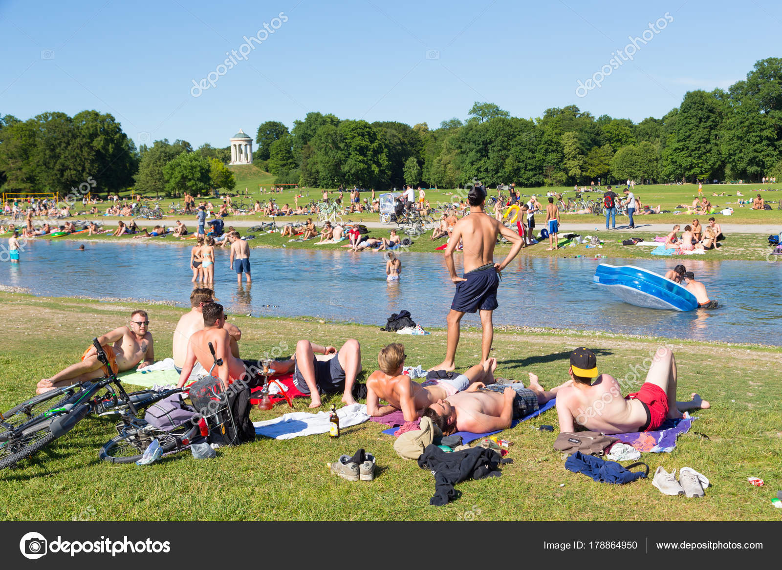 People Enjoying The Summer Day In Englischer Garten City Park In