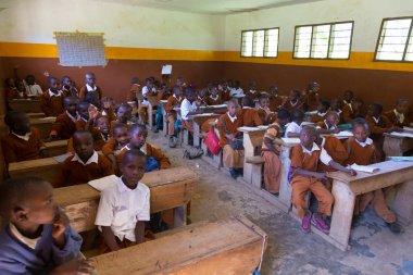 Çocuklar İlköğretim Okulu sınıf listetning öğretmeni Arusha, Tanzanya, Afrika yakınlarındaki kırsal alanda üniformalı.