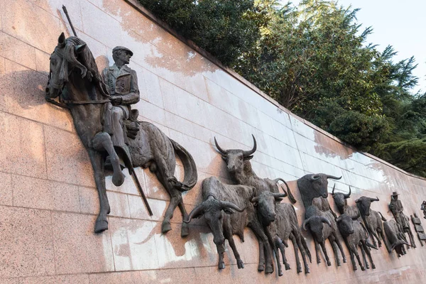 Wall statuee Run of Bulls at the Plaza de Toros de Las Ventas, Madrid, Spain.