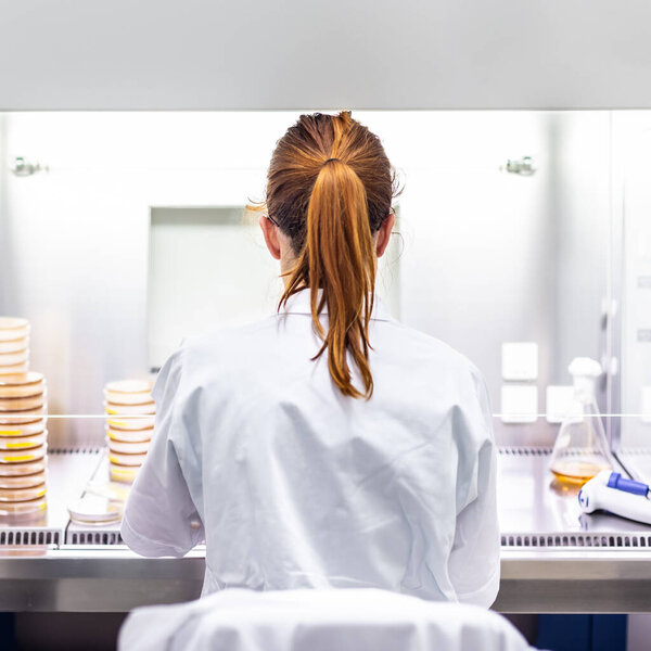 Female scientist working in corona virus vaccine development laboratory research facility.