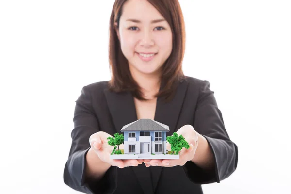 Real estate agent woman with house model — Stock Photo, Image