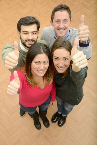 Smiling teamwork group with thumbs up