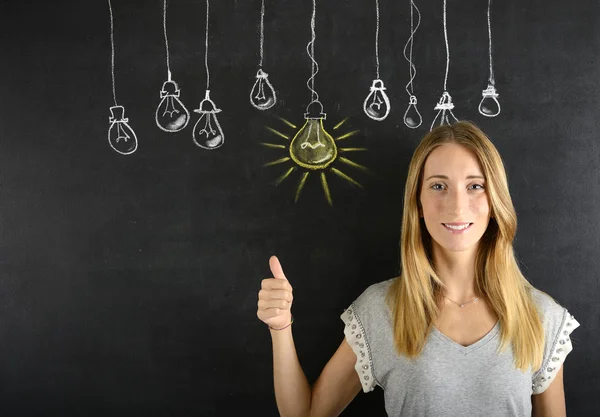 Happy woman with big ideas light bulb