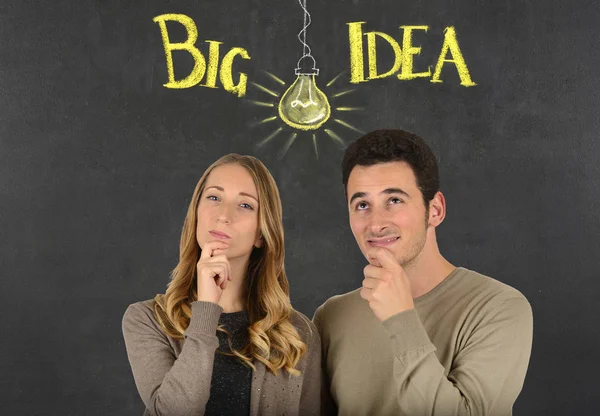 Pensive couple and big idea ligth bulb