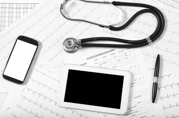 Medical exams: pulse trace, tablet and stethoscope