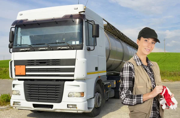 Young woman truck driver in front of truck