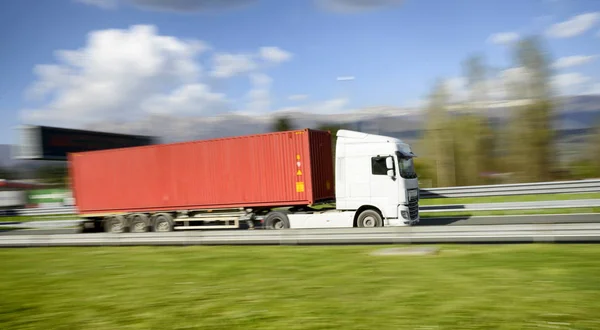 Truck on the road. Camera panning shot