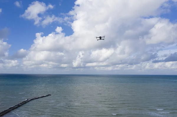 Drone flying over the sea, shooted from other drone
