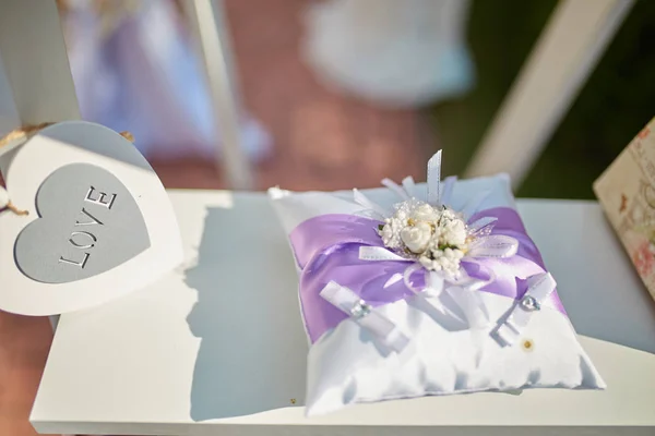 Jar with flowers hanging from chair for wedding