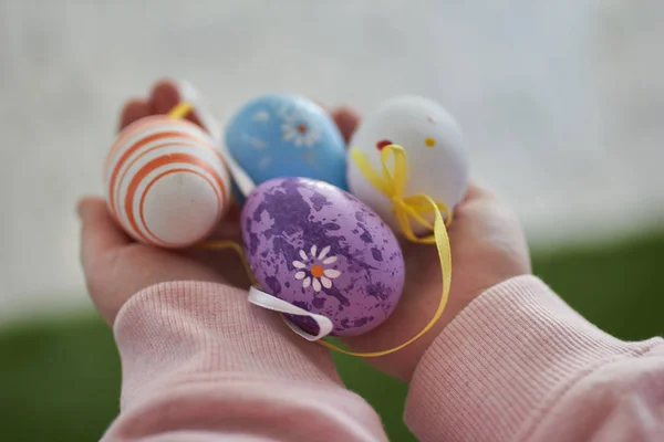 baby hands with colored easter eggs
