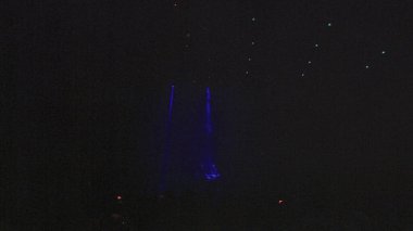 blurred image of people at the party. Crowd at the concert. Bright stage lights at night club