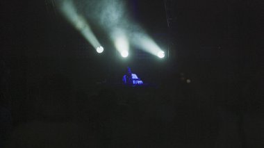 blurred image of people at the party. Crowd at the concert. Bright stage lights at night club