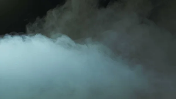 Photo of Real Smoke on a black background - realistic overlay for different projects. Clouds fog, mist, haze, vapor.