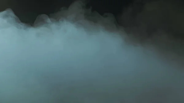 Photo of Real Smoke on a black background - realistic overlay for different projects. Clouds fog, mist, haze, vapor.