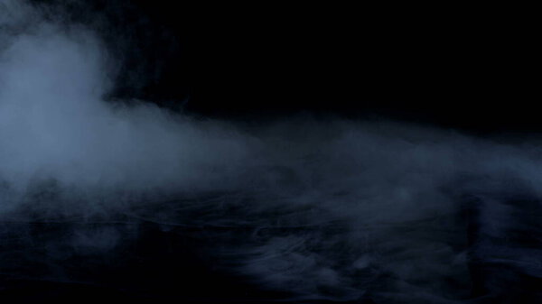 Real Smoke on black background photo. Dry Ice Hard Smoke.