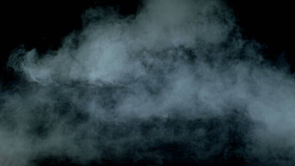 Real Smoke on black background photo. Dry Ice Hard Smoke.