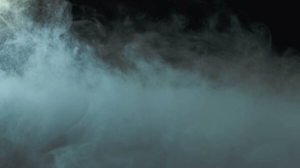 Real Smoke on black background photo. Dry Ice Hard Smoke.