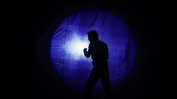 Staging of the battle of two guys, comedy, comedian boxing behind the curtain. Silhouettes of two comic fighting guys. A parody of the battle. It is convenient to use both maniac documentary stories.