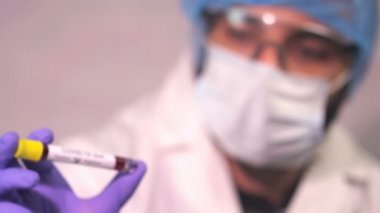 Doktor Coronavirus test tüpü, ncov kan testi gösteriyor. COVID-19 pozitif ve negatif test sonuçları. Doktor kan virüsü testi sonuçlarını gösteriyor. Kırmızı kamera yavaş çekim görüntüsü.