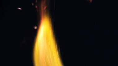 Şenlik ateşi kıvılcımlarının Macro fotoğrafı. Alevler patlar, patlamalar. Patlama mikro parlaklığı. Mini Havai fişekler. Kırmızı kamerada çekim hala siyah arkaplanda. Kıvılcım posteri, afiş, duvar kağıdı, doku.