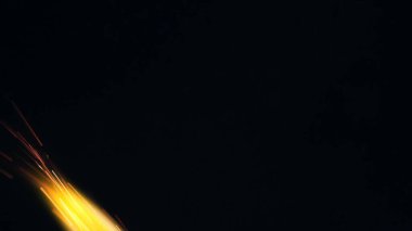 Şenlik ateşi kıvılcımlarının Macro fotoğrafı. Alevler patlar, patlamalar. Patlama mikro parlaklığı. Mini Havai fişekler. Kırmızı kamerada çekim hala siyah arkaplanda. Kıvılcım posteri, afiş, duvar kağıdı, doku.