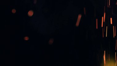 Şenlik ateşi kıvılcımlarının Macro fotoğrafı. Alevler patlar, patlamalar. Patlama mikro parlaklığı. Mini Havai fişekler. Kırmızı kamerada çekim hala siyah arkaplanda. Güzel sızıntılar kıvılcım posteri, afiş, duvar kağıdı, arkaplan, doku.