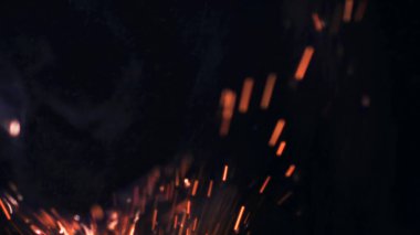 Şenlik ateşi kıvılcımlarının Macro fotoğrafı. Alevler patlar, patlamalar. Patlama mikro parlaklığı. Mini Havai fişekler. Kırmızı kamerada çekim hala siyah arkaplanda. Güzel sızıntılar kıvılcım posteri, afiş, duvar kağıdı, arkaplan, doku.