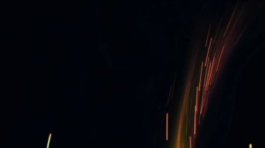 Şenlik ateşi kıvılcımlarının Macro fotoğrafı. Alevler patlar, patlamalar. Patlama mikro parlaklığı. Mini Havai fişekler. Kırmızı kamerada çekim hala siyah arkaplanda. Güzel sızıntılar kıvılcım posteri, afiş, duvar kağıdı, arkaplan, doku.