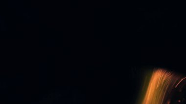 Şenlik ateşi kıvılcımlarının Macro fotoğrafı. Alevler patlar, patlamalar. Patlama mikro parlaklığı. Mini Havai fişekler. Kırmızı kamerada çekim hala siyah arkaplanda. Güzel sızıntılar kıvılcım posteri, afiş, duvar kağıdı, arkaplan, doku.