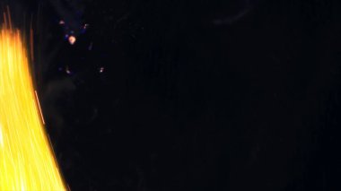 Şenlik ateşi kıvılcımlarının Macro fotoğrafı. Alevler patlar, patlamalar. Patlama mikro parlaklığı. Mini Havai fişekler. Kırmızı kamerada çekim hala siyah arkaplanda. Güzel sızıntılar kıvılcım posteri, afiş, duvar kağıdı, arkaplan, doku.