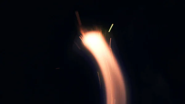 Macro photo of Bonfire sparks. Fire Flames bursts, blasts. Explosion micro sparkles. Mini Fireworks. Shooting on Red camera still on black background. Beautiful leaks overlay spark.