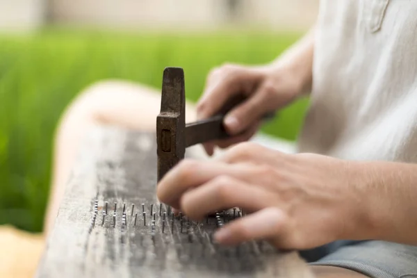 Caucasian woman makes handmade  board with nails — Stock Photo, Image