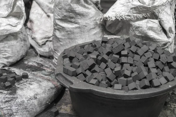 Bowl of charcoal cubes for hookah Stock Picture