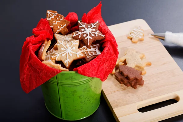 Idea DIY Do it yourself new year and Christmas gift concept butter sugar cookies with royal icing decoration in green bucket with copy space