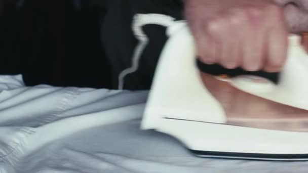 A man Ironing a white shirt iron — Stock Footage A man Ironing a white shirt iron Stock Footage