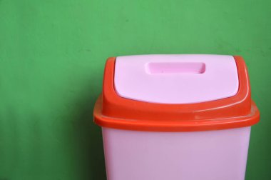 yeşil duvar üzerinde pembe plastik kutuları