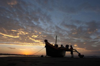 silhouette of fisherman at the beach