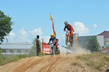 TARAKAN, İndonezya. 13 Mayıs 20176 Grasstrack motosiklet yarışçısı bir tepecikte uçuyor.