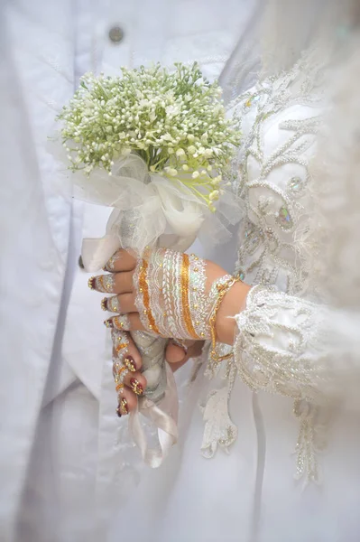 印度尼西亚新娘的手捧着花束 手里拿着白木瓜和白母鸡 — 图库照片