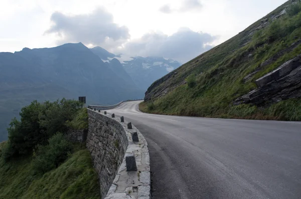 Serpentinenstraße und schöne Wolken hoch in den Bergen, österreichische Alp Stockbild