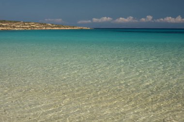 Crystal clear waters of Pori Beach at Koufonisi Island in Greece clipart