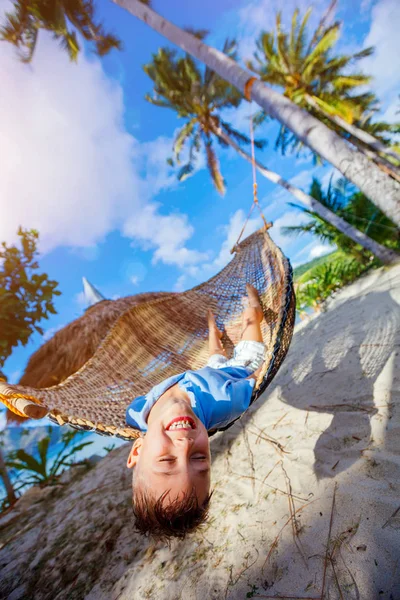 Niño pequeño relajándose en una playa tropical en hamaca . — Foto de Stock