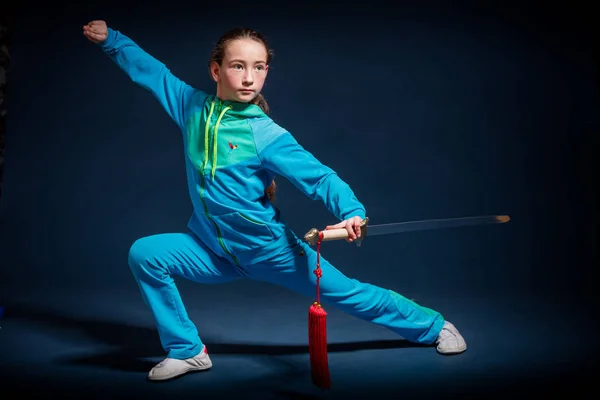Girl in a blue wear engaged wushu — Stock Photo, Image