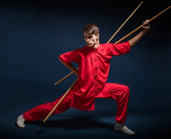 Boy in a red kimono engaged wushu — Stock Photo, Image