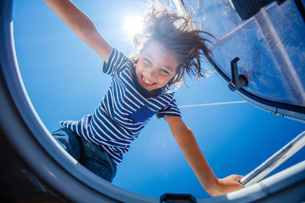 Little boy on board of sailing yacht on summer cruise. Travel adventure, yachting with child on family vacation. — Stock Photo, Image