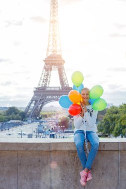Renkli balonlar Paris'te Eyfel Kulesinin yakınında grup ile kız.