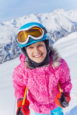 Young skier in winter resort clipart